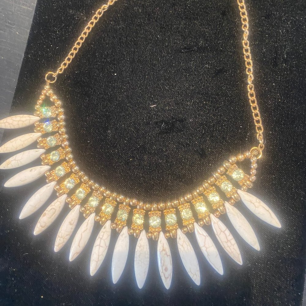 No elephants were harmed to  make this "ivory" and diamond" necklace